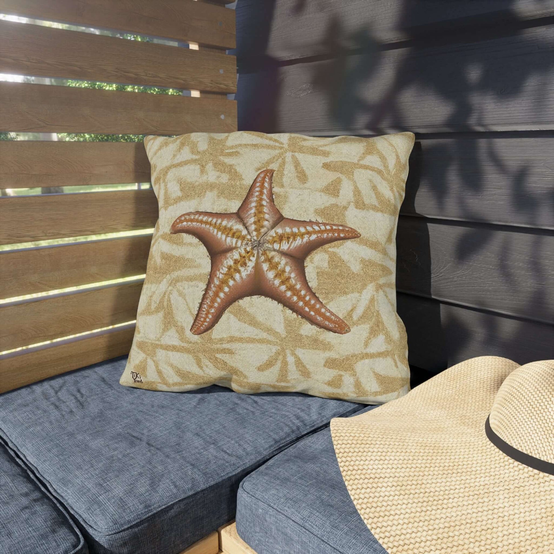 Island Star outdoor throw pillow on a patio chair, coastal starfish design, enhancing tranquil beach vibes