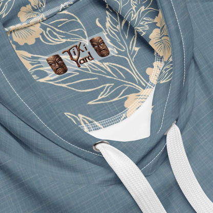 Close-up view of Hawaiian hoodie with tiki mask zipper pull and floral print inside hood