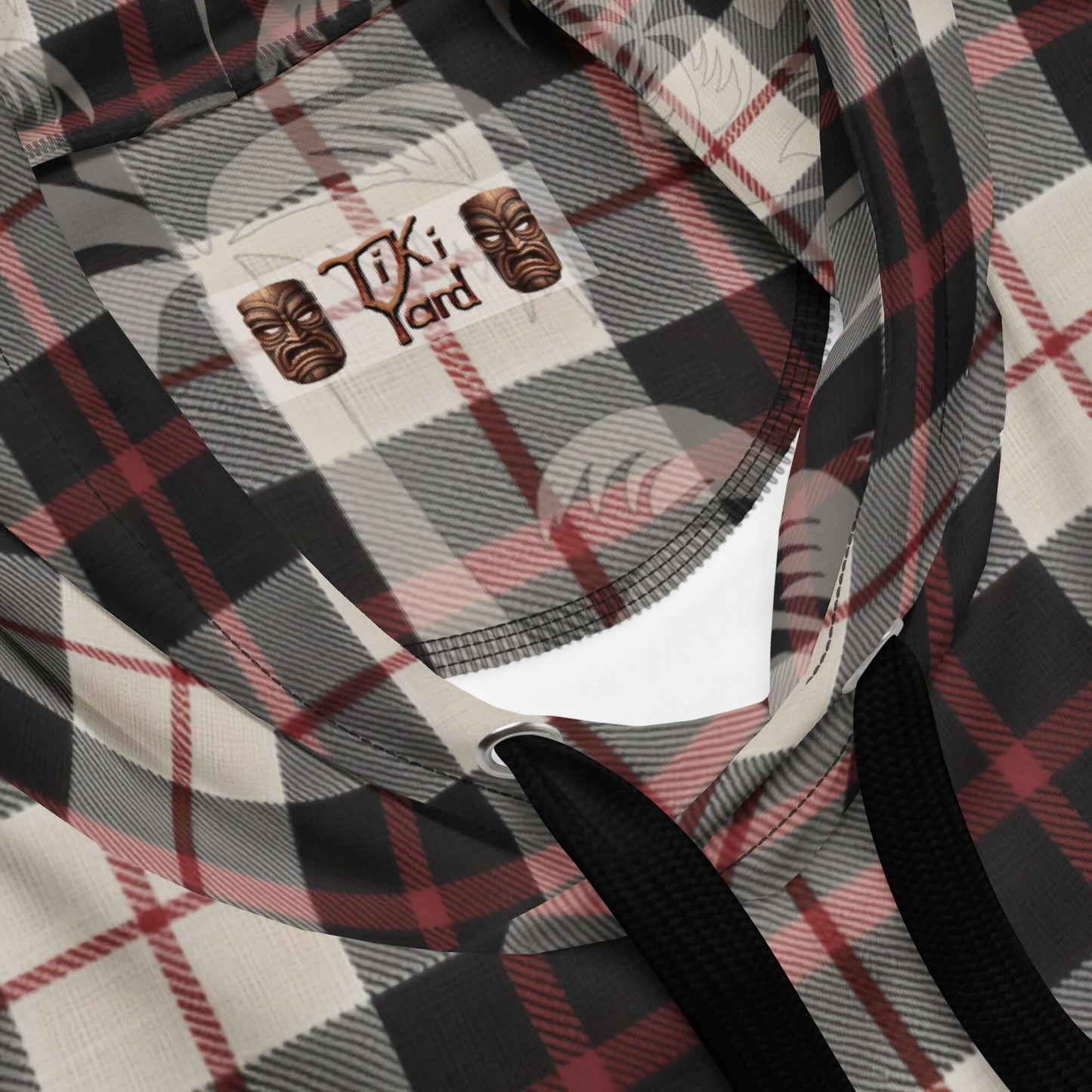 Close-up of Tiki Hotrod Hawaiian Hoodie with plaid design and logo on the neck panel