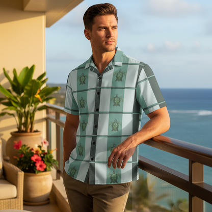 Man wearing Island Spirit Elua Hawaiian shirt with seafoam green plaid and sea turtle pattern relaxing on ocean-view lanai at upscale Hawaiian resort