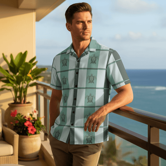 Man wearing Island Spirit Elua Hawaiian shirt with seafoam green plaid and sea turtle pattern relaxing on ocean-view lanai at upscale Hawaiian resort