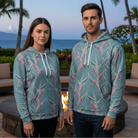 Man and woman wearing Pacific Dreams pullover Hawaiian hoodies by resort firepit during cool Hawaiian evening