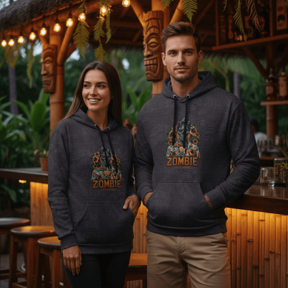 Couple wearing matching Let's Drink pullover hoodies with zombie tiki design at Hawaiian tiki bar