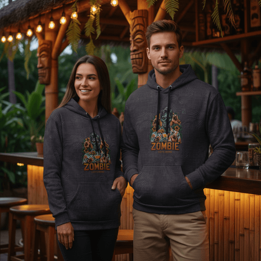 Couple wearing matching Let's Drink pullover hoodies with zombie tiki design at Hawaiian tiki bar